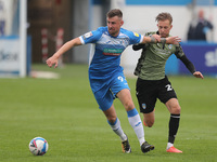   Scott Quigley of Barrow in action with Ben Stevenson of Colchester United during the Sky Bet League 2 match between Barrow and Colchester...