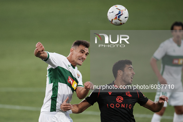 Dani Calvo of Elche and Mikel Merino of Real Sociedad compete for the ball during the La Liga Santader match between Elche CF and Real Socie...