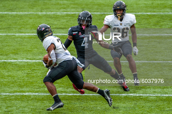 Army’s Tyrell Robinson (21) returns a punt during an NCAA college football game at Nippert Stadium between the University of Cincinnati Bear...