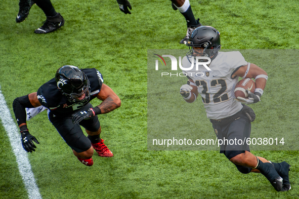Army running back Artice Hobbs (32) runs the ball upfield during an NCAA college football game at Nippert Stadium between the University of...
