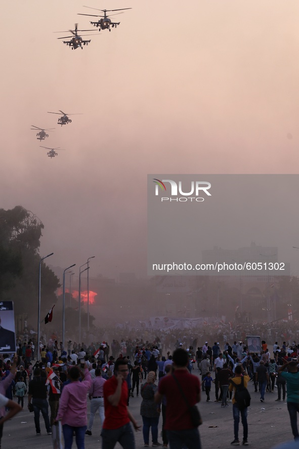 Egyptian military helicopters fly over supporters of Egyptian President Abdel Fattah al-Sisi, held on the occasion the 6th of October war an...