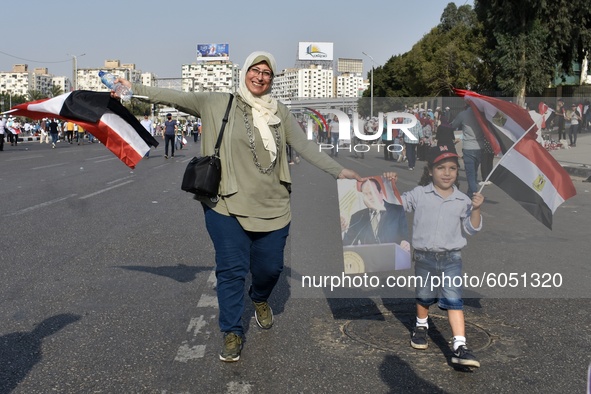 Supporters of Egyptian President Abdel Fattah al-Sisi dance and wave flags during, held on the occasion the 6th of October war anniversary,...