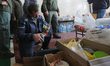 A volunteer man inspects things brought by people to the temporarily center for evacuees i...