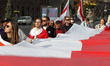 People hold the historical white-red-white flags of Belarus during a rally of solidarity w...
