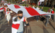 People hold the historical white-red-white flags of Belarus during a rally of solidarity w...