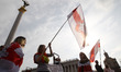 People hold the historical white-red-white flags of Belarus during a rally of solidarity w...