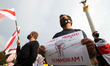 People attend a rally of solidarity with Belarusian protests on Independence Square in Kyi...