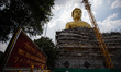 A giant Buddha statue under construction at Wat Paknam Bhasi Charoen temple in west of Ban...