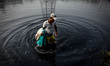 People washing cloths using dirty water of Burigonga River, in Dhaka, Bangladesh, on March...