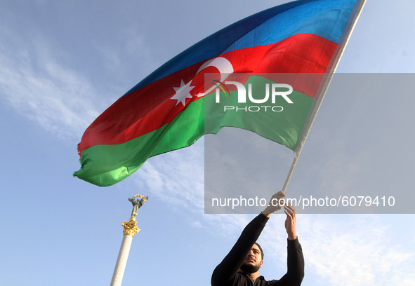 An Azerbaijani man who lives in Ukraine waves Azerbaijan's flag during a rally in support Azerbaijan against Armenia in the Nagorno-Karabakh...