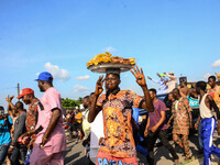 People celebrate on October 10, 2020 in a street of Owo in Ondo, the re-election of Rotimi Akeredolu as Ondo State Governor after defeating...
