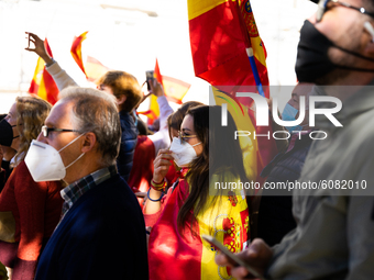 Demonstrators protesting against the government in front of the Royal Palace during the institutional act for the national day of Spain in M...