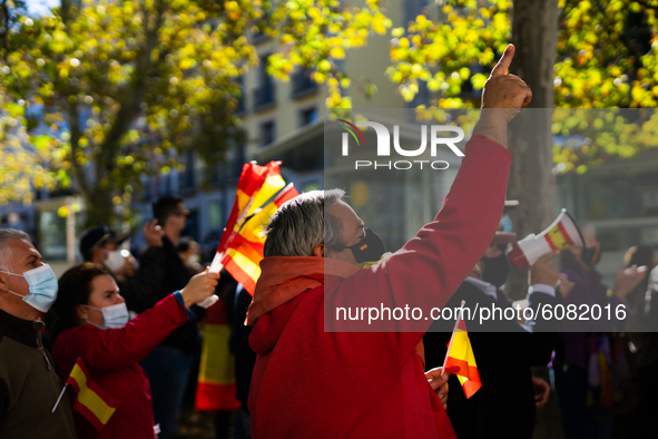 Demonstrators protesting against the government in front of the Royal Palace during the institutional act for the national day of Spain in M...