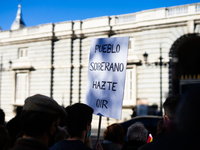 Protester holding a sign where you can read "People make yourself heard" against the government in front of the Royal Palace during the inst...
