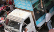 A health worker collects a nasal swab sample from people during weekly market for Covid-19...