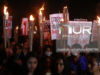 Bangladeshi female activists and students take part in a torch-lit protest demanding women's safety and justice for rape victims in Dhaka, B...