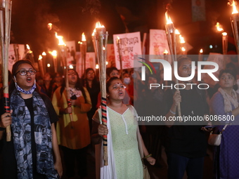 Bangladeshi female activists and students take part in a torch-lit protest demanding women's safety and justice for rape victims in Dhaka, B...