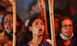 Students and activists take part in a torch-lit march during an ongoing protest against an...