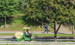 Worker mowing the grass on a self-propelled mower is seen in Gdynia, Poland, on 17 Septemb...