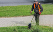 Worker mowing grass with a brush cutter, lawn mower is seen in Gdynia, Poland, on 17 Septe...