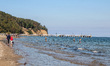 People enjoying last warm days of summer walking, jogging and resting at the Baltic Sea co...