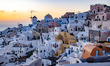 Magic hour in the dusk just after the sunset in the famous Oia Village with blue dome chur...