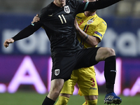 Michael Gregoritsch of Austria in action against Alin Tosca of Romania  during the UEFA Nations League match between Romania v Austria, in P...