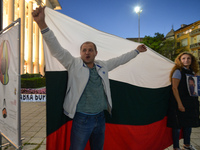 Protesters with a Bulgarian national flag seen in Burgas city center.
Bulgarians have been demonstrating in Sofia and around the country for...