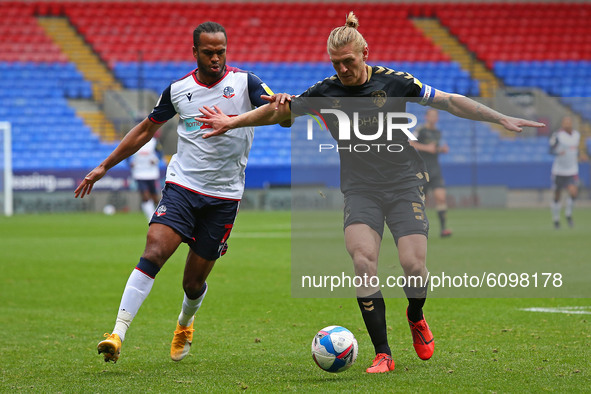  Boltons Nathan clashes with Oldhams Carl Piergianni during the Sky Bet League 2 match between Bolton Wanderers and Oldham Athletic at the R...