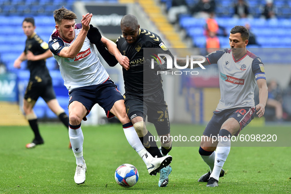 Bolton Wanderers' Ryan Delaney and Antoni Sarcevic and Oldham Athletic's Dylan Bahamboula in action during the Sky Bet League 2 match betwee...