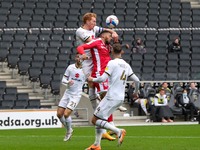 Milton Keynes Dons captain Dean Lewington heads the ball clear during the first half of the Sky Bet League One match between MK Dons and Gil...