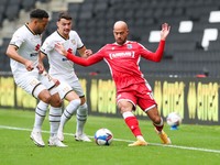 Gillingham's Jordan Graham is challenged by Milton Keynes Dons Regan Poole during the first half of the Sky Bet League One match between MK...