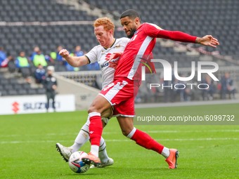 Milton Keynes Dons captain Dean Lewington is challenged by Gillingham's Dominic Samuel during the first half of the Sky Bet League One match...