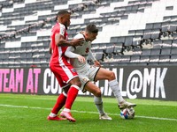 Milton Keynes Dons Daniel Harvie is challenged by Gillingham's Ryan Jackson during the second half of the Sky Bet League One match between M...