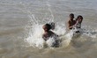 Boys  jump in the Brahmaputra river during an a hot summer day in Guwahati ,india on Oct 1...
