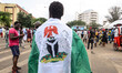 A protester wraps himself with himself with the Nigerian National Flag, in Lagos on Octobe...
