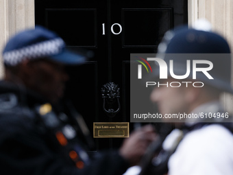 Police officers talk outside 10 Downing Street in London, England, on October 19, 2020. (