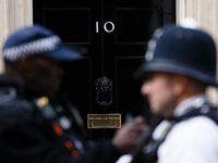 Police officers talk outside 10 Downing Street in London, England, on October 19, 2020. (