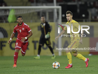 Darius Olaru of Romania U21 in action against Omar Elouni of Malta U21 during  the soccer match between Romania U21 and Malta U21 of the Qua...