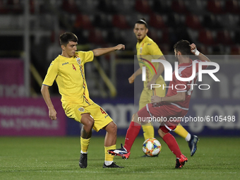 Stefan Vladoiu of Romania U21 in action against James Scicluna  of Malta U21 during  the soccer match between Romania U21 and Malta U21 of t...