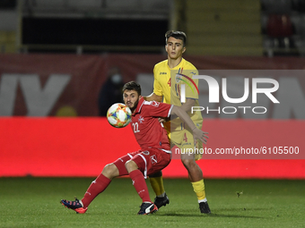 Stefan Vladoiu of Romania U21 in action against James Scicluna of Malta U21 during  the soccer match between Romania U21 and Malta U21 of th...