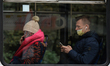 People wearing protective masks inside a local tram in the center of Krakow.The number of...