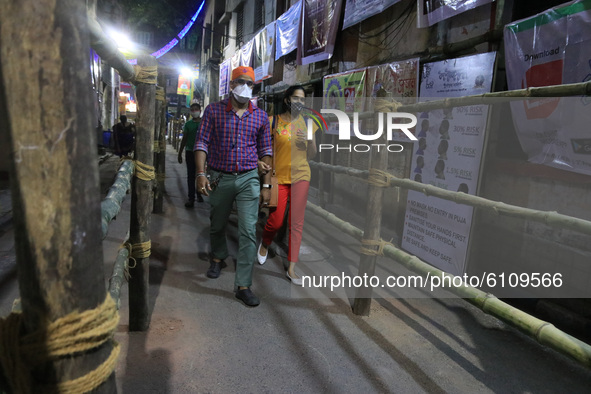 Visitor walk barricade of community puja pandal  ahead of the Hindu festival 'Durga Puja' in Kolkata ,India on October 21,2020. Durga puja p...