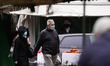 A man and a woman are seen wearing face masks at a market in Warsaw, Poland on October 23,...