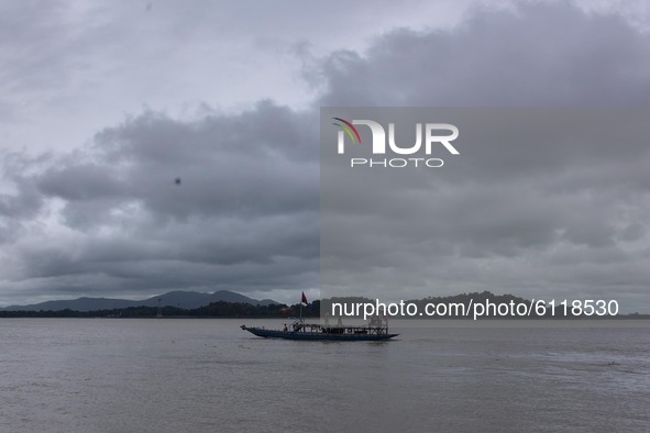 A boat cross the river Brahmaputra as dark clouds gather in the sky, in Guwahati, India on 24 October 2020. 