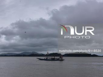 A boat cross the river Brahmaputra as dark clouds gather in the sky, in Guwahati, India on 24 October 2020. (