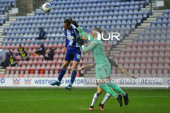 Plymouth keeper Michael Cooper gets to the ball before Wigans Will Keane    during the Sky Bet League 1 match between Wigan Athletic and Ply...
