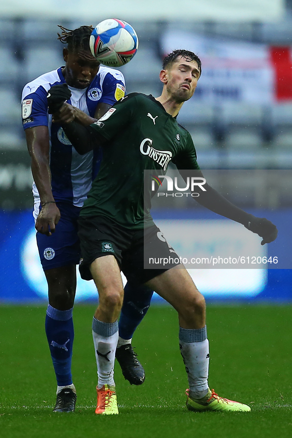 Plymouths Ryan Hardie battles with Wigans Darnell Johnson during the Sky Bet League 1 match between Wigan Athletic and Plymouth Argyle at th...