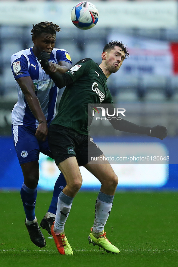 Plymouths Ryan Hardie battles with Wigans Darnell Johnson during the Sky Bet League 1 match between Wigan Athletic and Plymouth Argyle at th...