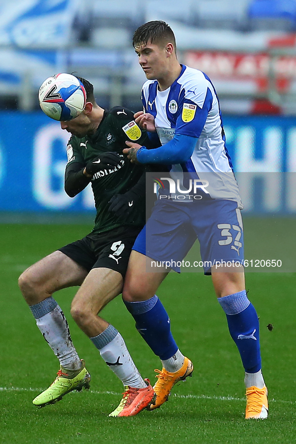 Wigans Adam Long holds off Plymouths Ryan Hardie during the Sky Bet League 1 match between Wigan Athletic and Plymouth Argyle at the DW Stad...